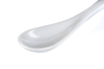 White ceramic spoon isolated on a white background