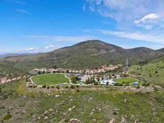 Fototapeta na wymiar Aerial view of small community park with playground for kids in upper middle class neighborhood with residential subdivision houses during sunny day in San Diego, California, USA.
