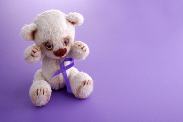 Epilepsy day.Health care concept. Teddy bear with purple ribbon. Epilepsy or Cancer hope.