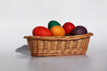 Easter eggs colors in basket white background