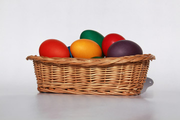 Easter eggs colors in basket white background