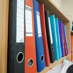 folders with documents on the shelf in the office
