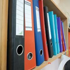 folders with documents on the shelf in the office