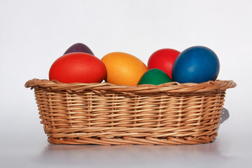 Fototapeta na wymiar Easter eggs colors in basket white background