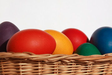 Easter eggs colors in basket white background