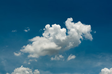 Naklejka na ściany i meble White puffy clouds on a vivid blue sky in sunny day.