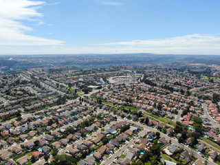 Aerial view of upper middle class neighborhood with residential subdivision houses during sunny day in San Diego, California, USA.