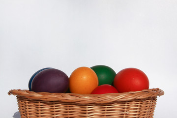 Easter eggs colors in basket white background
