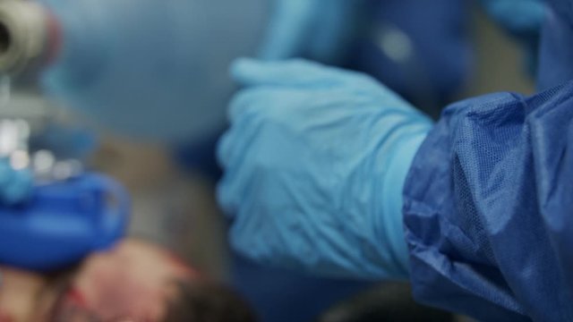 Doctors and nurses treating a wounded patient in a hospital Emergency room