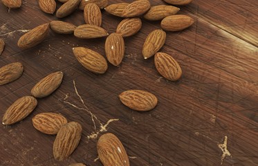 Almonds spread on a wooden surface