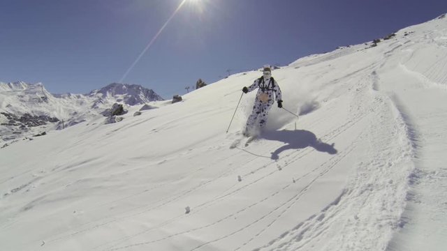 Skier in a animal suit skiing trough powder snow in slow motion