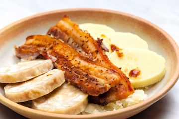 pork meat with two types of dumplings and cabbage