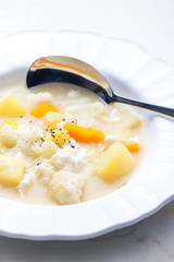 cauliflower soup with carrot, potato and egg