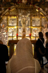 A devotee prays in front of the crucified Christ in the Chapel of the Crucifixion in the Church of the Holy Sepulchre