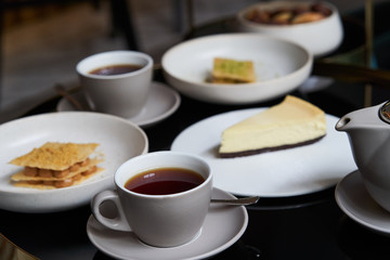 Sweets dessert cookies cake and teapot with cups