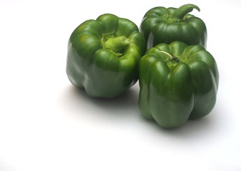 Three green peppers on a white background.