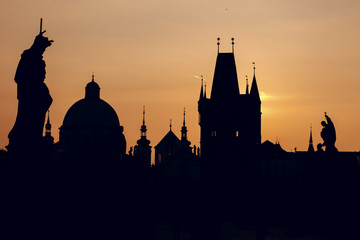 Fototapeta na wymiar silhouette of cathedral and tower on the Charles Bridge at sunrise