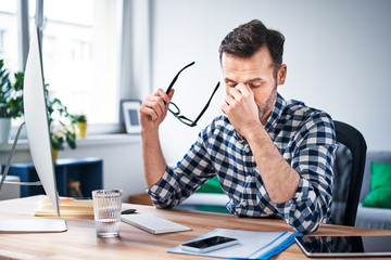 Frustrated, overworked freelancer working from home office