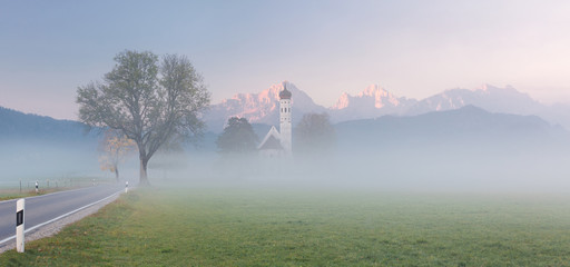 Coloman Church in morning mist, Colomanskirche in Schwangau, Bavaria, Germany.
