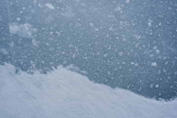 Fototapeta na wymiar Blue background ice and snow on a winter lake.