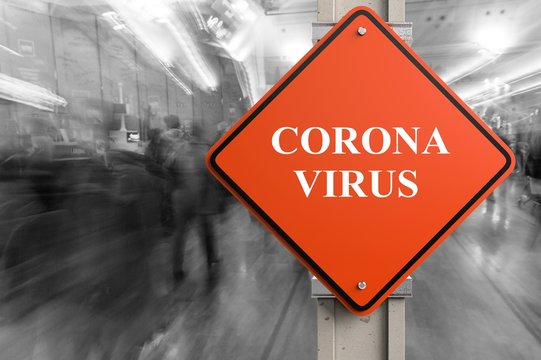 Coronavirus written on a stop sign on airport background.