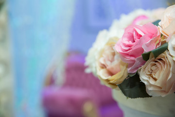 wedding table, wedding decorations . Large vase with beautiful roses stands on rich served dinner table .Wedding flower composition for guest . Beautiful pink and white flowers on table .