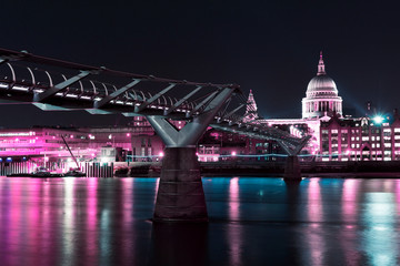 Fototapeta na wymiar St Paul's Cathedral and the Millennium Bridge, London at night in cyberpunk colours