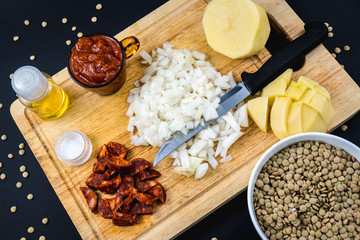 Ingredients tomato, onion, chorizo and potatoes. Homemade recipe of a Spanish lentil dish
