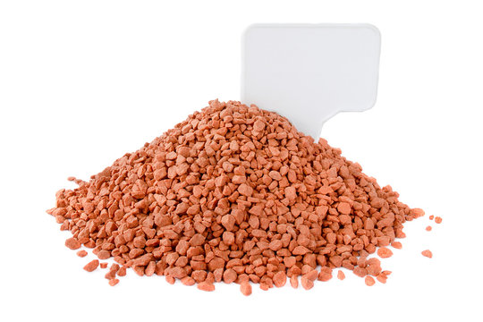 Potassium chloride, a place for an inscription. Pile of red mineral fertilizers on a white background with. Potassium chloride is isolated on a white background. Granules of potassium chloride.
