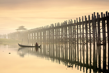 Sunrise over the historic wooden U Bein Bridge with fisherman near Mandalay in Myanmar