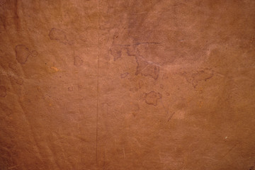 Texture of old brown worn antique leather with spots