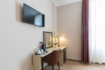 Interior of a small hotel room, work area