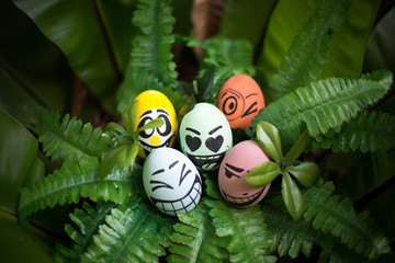 Perfect colorful handmade easter eggs with green plant isolated on a green background. Easter day concepts. Funny decoration. Happy Easter.