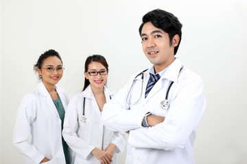 Fototapeta premium Young asian malay chinese male female doctor on white background posing confident looking at camera
