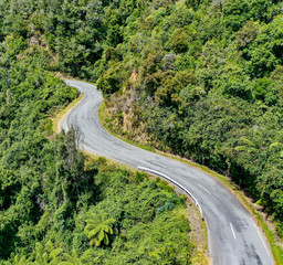 Fototapeta premium Winding Road in the tropical mountains, aerial view