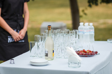 the waiter pours champagne in glasses on the street - wedding catering