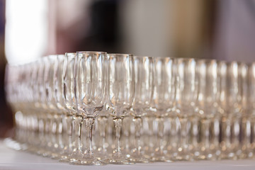 Empty glasses for wine and champagne in a row at the banquet table