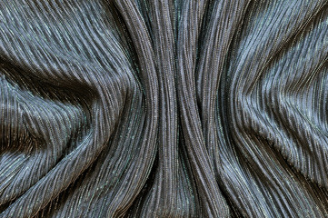 Folds of light artificial fabric.