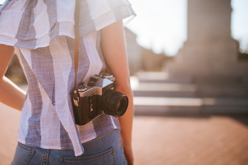  A beautiful young girl with a camera in the square