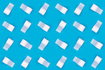 Pattern of toilet paper rolls on the bright blue background. Coronavirus COVID-19 pandemic panic shopping, social distancing concept. Bright monochrome drop