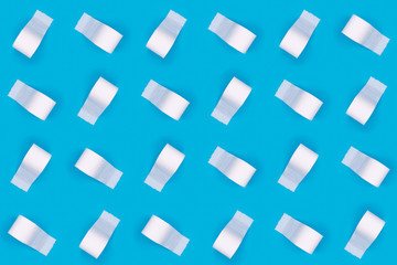 Pattern of toilet paper rolls on the bright blue background. Coronavirus COVID-19 pandemic panic shopping, social distancing concept. Bright monochrome drop