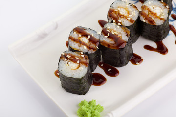 Japanese Cuisine - Appetizing Salmon Sushi Set. Philadelphia Sushi Roll - Maki Sushi with Philadelphia Cheese inside on mirror black background. Smoked salmon rolls served on a plate