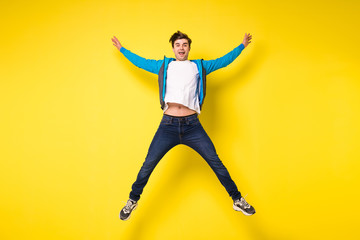 Fototapeta na wymiar jumping man on yellow background
