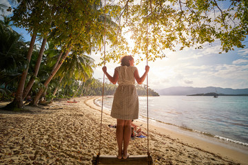 Attractive black woman on a swing at the 