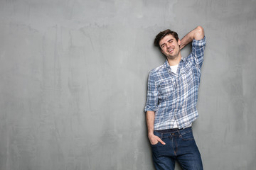 young man standing on a concrete wall