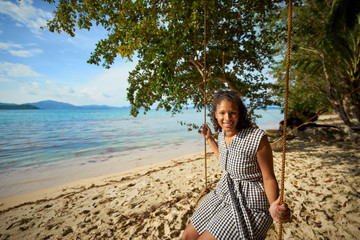 Attractive black woman on a swing at the 