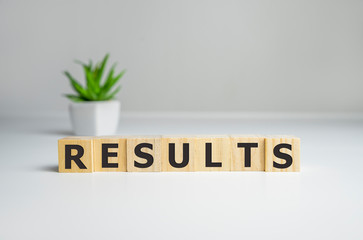 Results - words from wooden blocks with letters, result concept, top view background