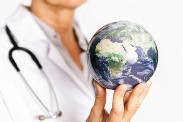 female doctor holding planet earth on her fingertips. Showing Africa map