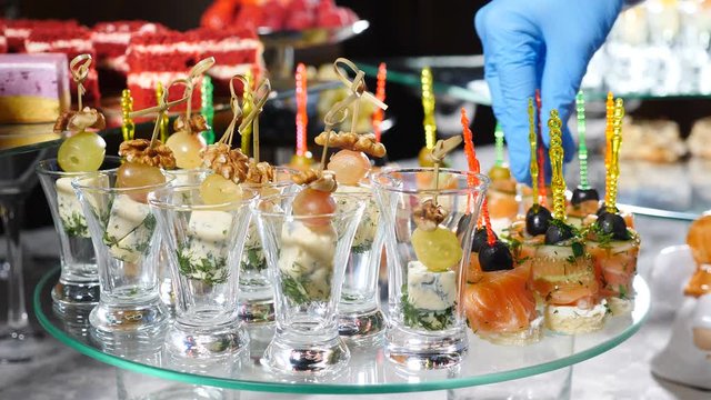 Restaurant snacks serving. Beautifully decorated catering banquet table with canape in hotel. catering service buffet food set in event celebration, corporate or birthday party or wedding. 4 k video