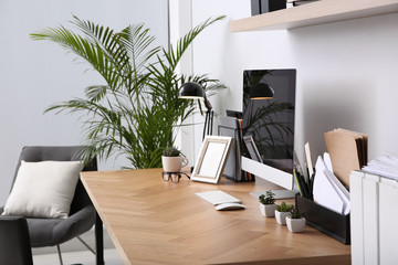 Modern computer on table in office interior. Stylish workplace